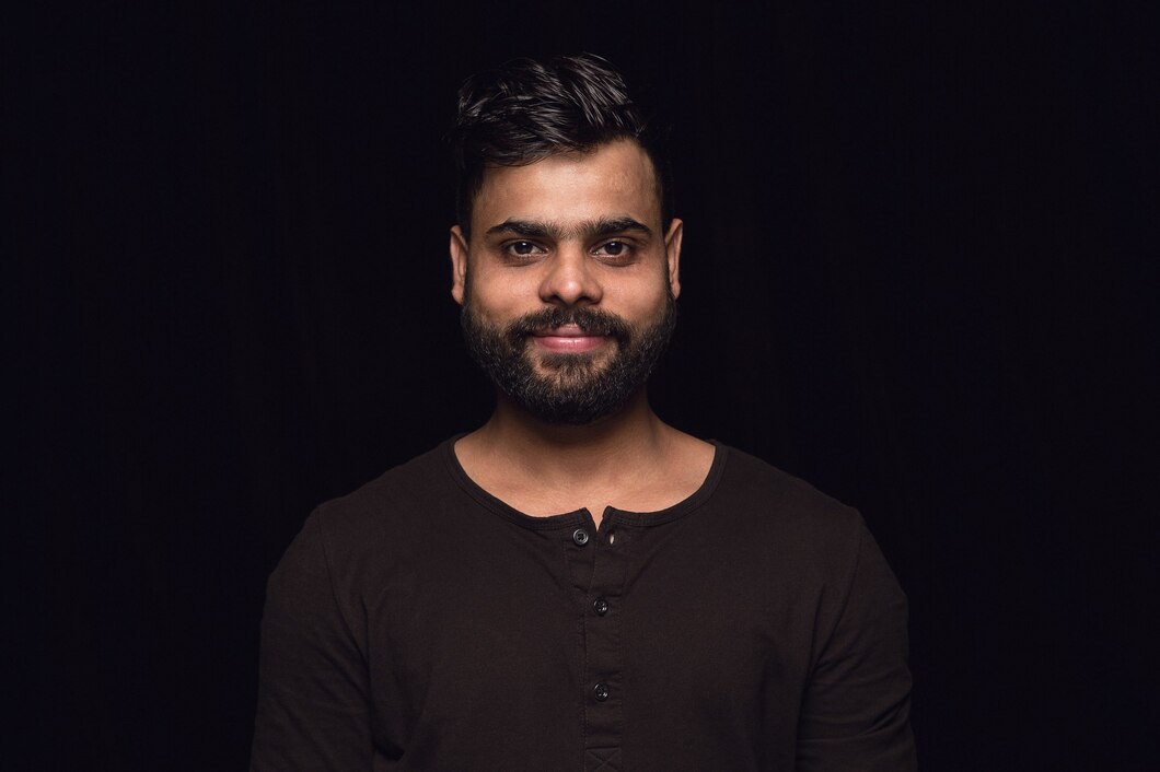 close-up-portrait-young-man-isolated-black-wall-photoshot-real-emotions-male-model-smiling-feeling-happy-facial-expression-pure-clear-human-emotions-concept_155003-28040